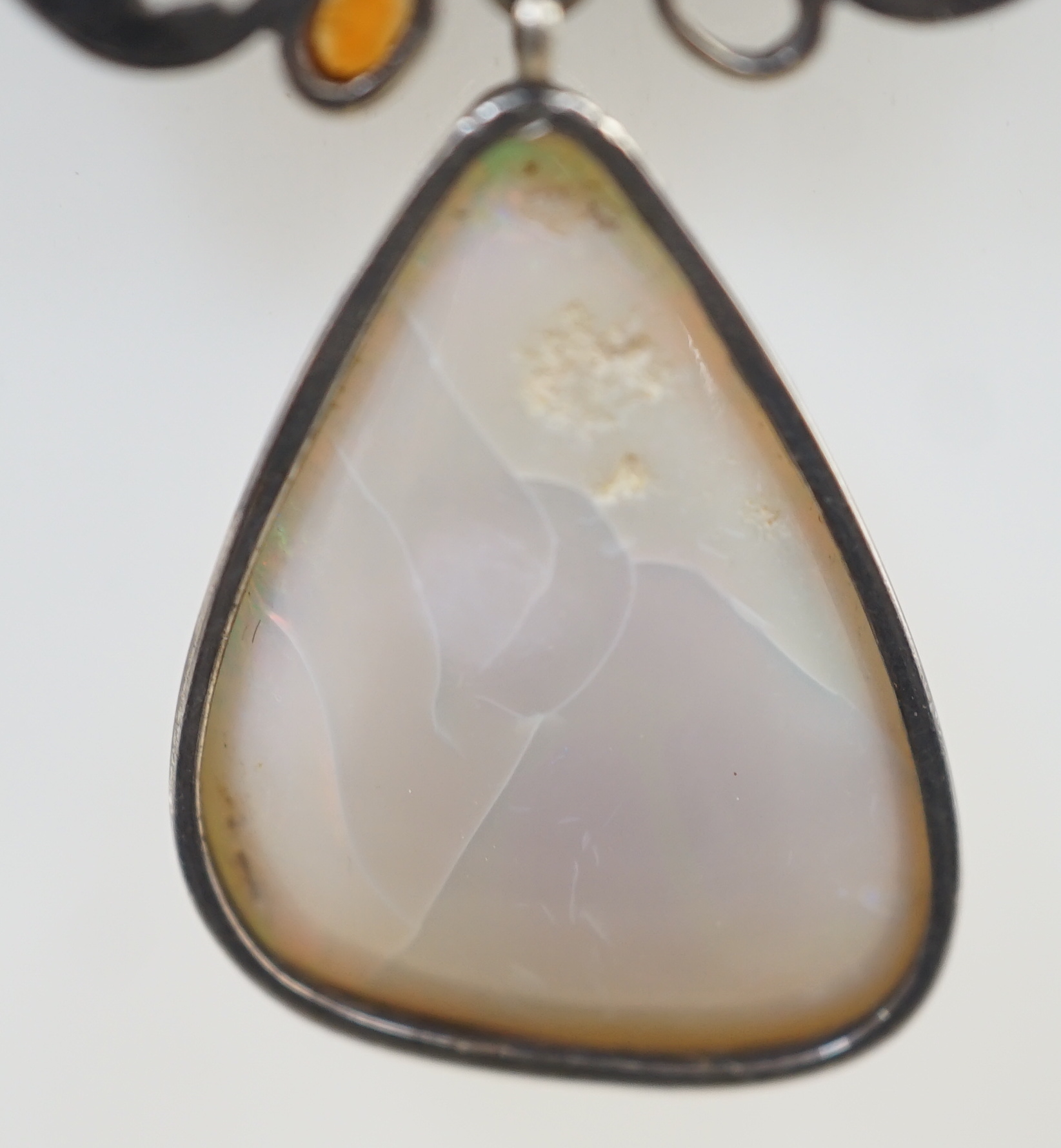 An early 20th century silver, white opal and cabochon gem cluster set drop pendant necklace, in the manner of Sibyl Dunlop